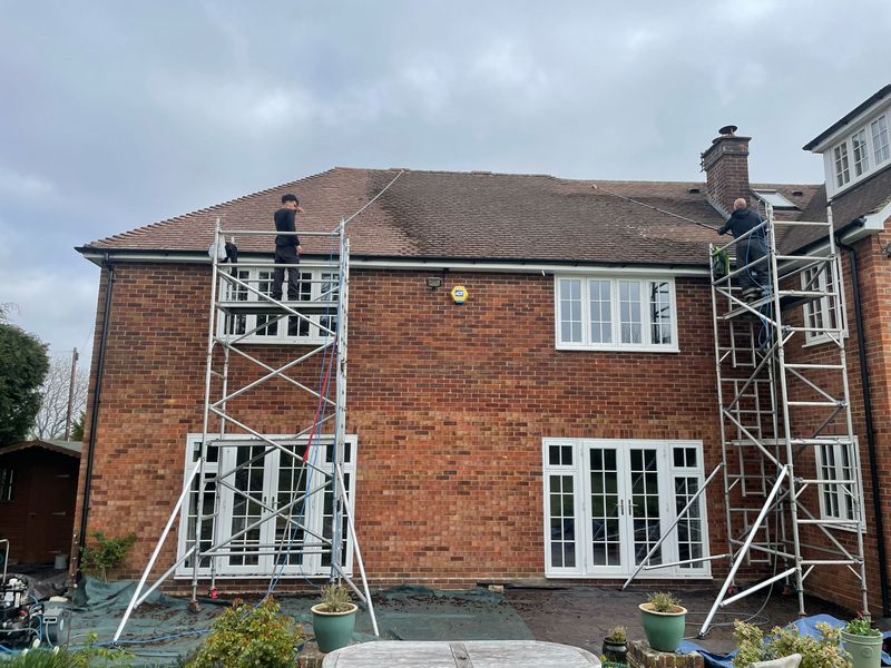 Roof cleaning carried out safely from scaffold towers by The Roof Moss Cleaners in Sunningdale